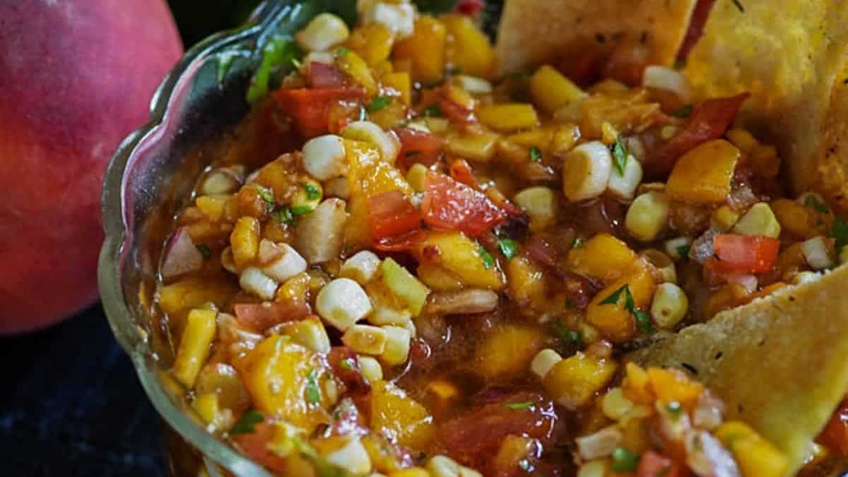 Peach Salsa in a bowl with homemade pita chips