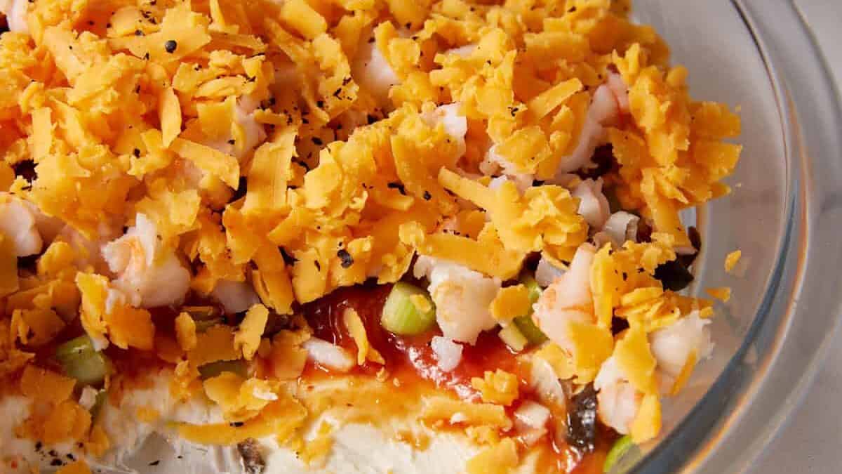 A scoop removed showing the layers of a shrimp dip.