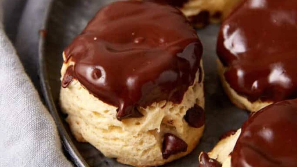 Chocolate covered biscuits on a plate with a fork.