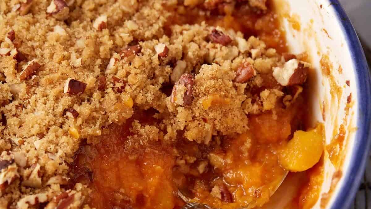 A serving spoon in a sweet potato casserole.