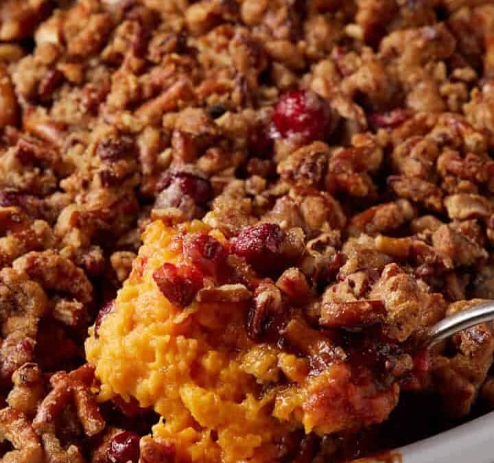 A large spoon full of sweet potato casserole.