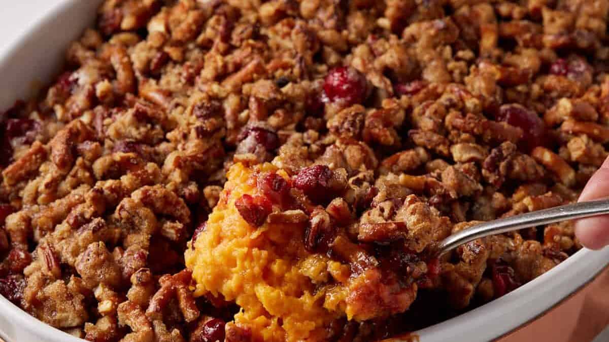 A large spoon full of sweet potato casserole.