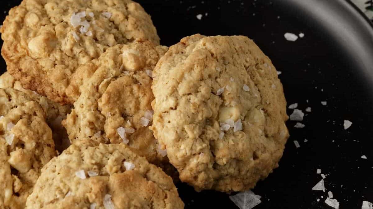 A plate of oatmeal cookies with a glass of milk.