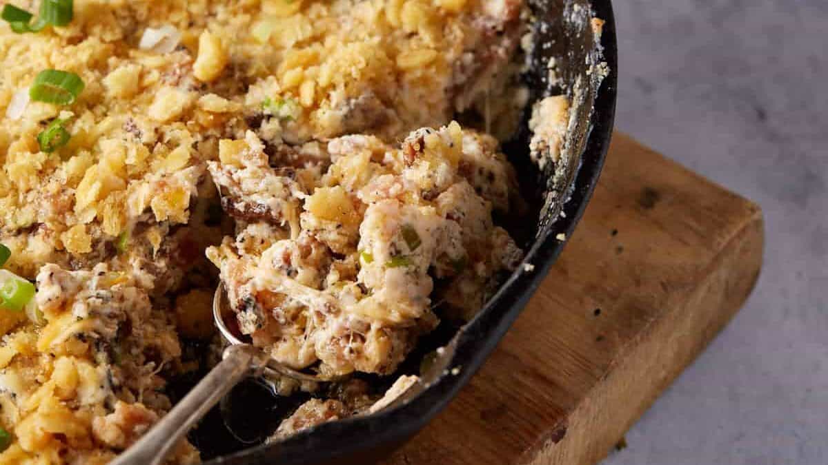 A cast iron skillet filled with bacon dip.