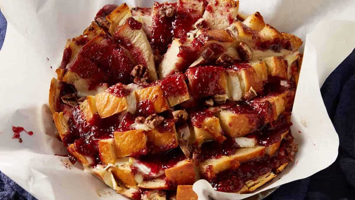 Bread stuffed with brie on parchment paper.