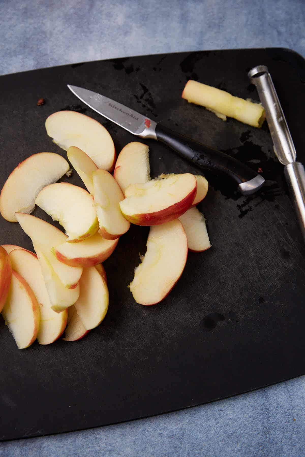 Apples cut on a cutting board.