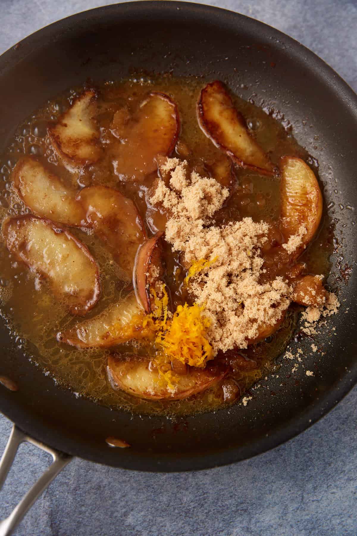 Apples in a skillet with brown sugar.