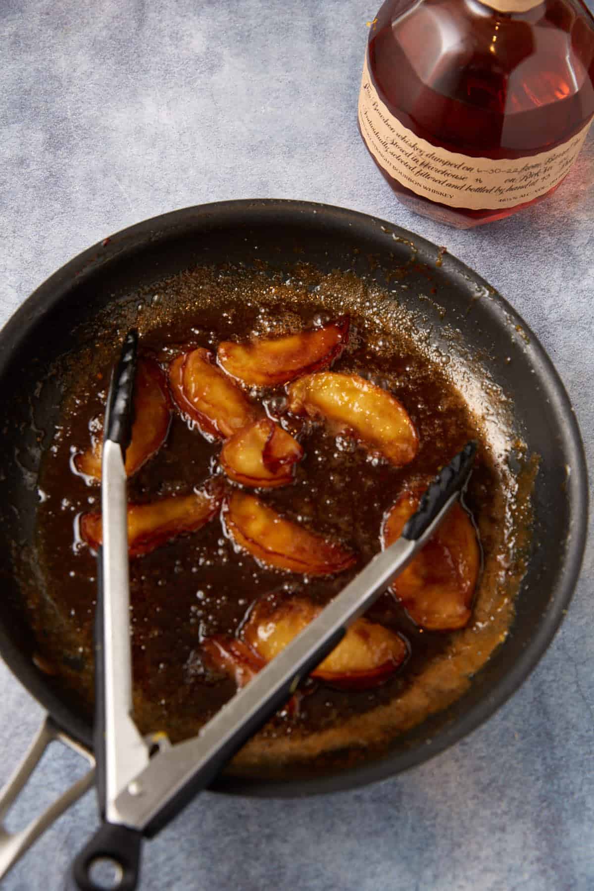 A skillet with apples and sauce.
