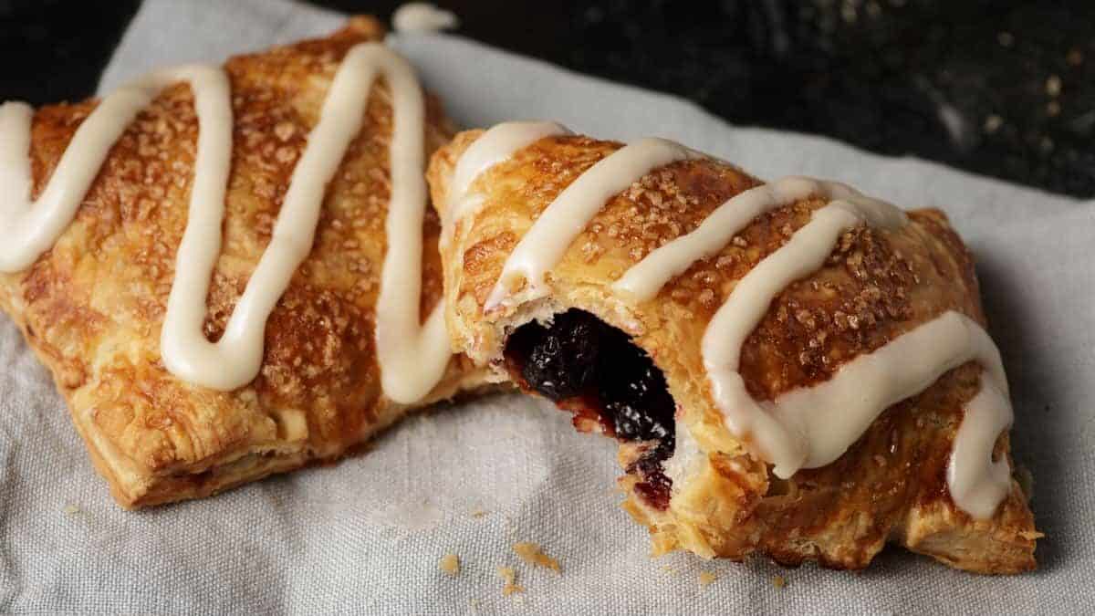 Cherry hand pies on a linen napkin with a bite taken out