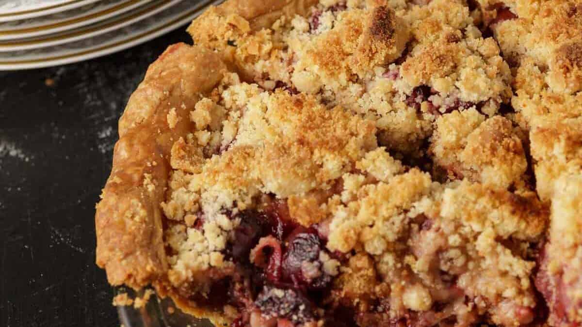 A cherry streusel pie with a slice removed.