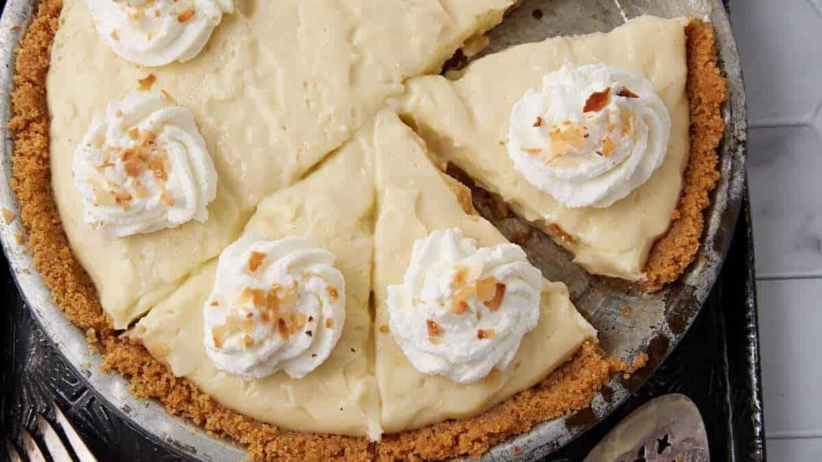 A coconut custard pie with a slice removed.