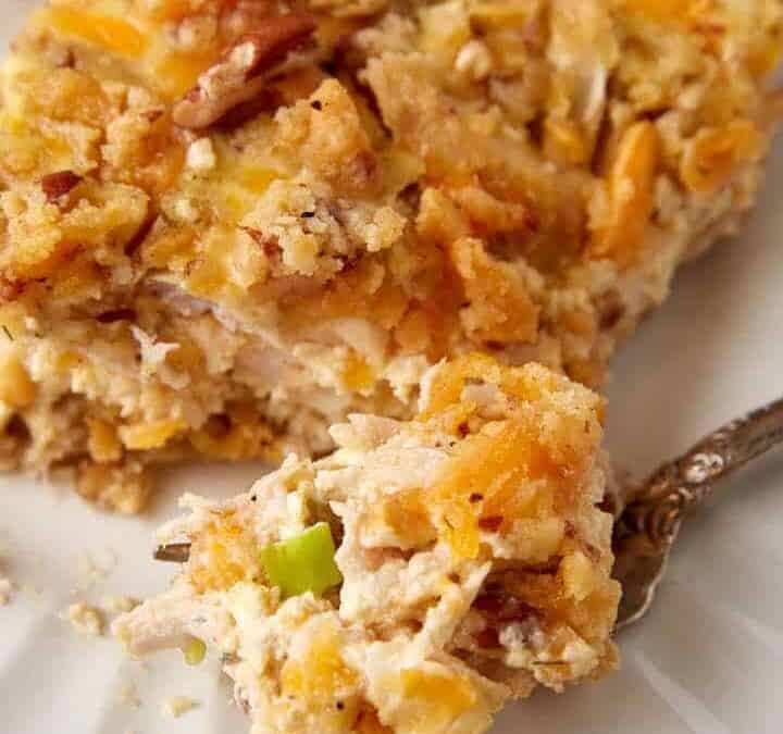 A single serving of pecan chicken casserole on a white plate.