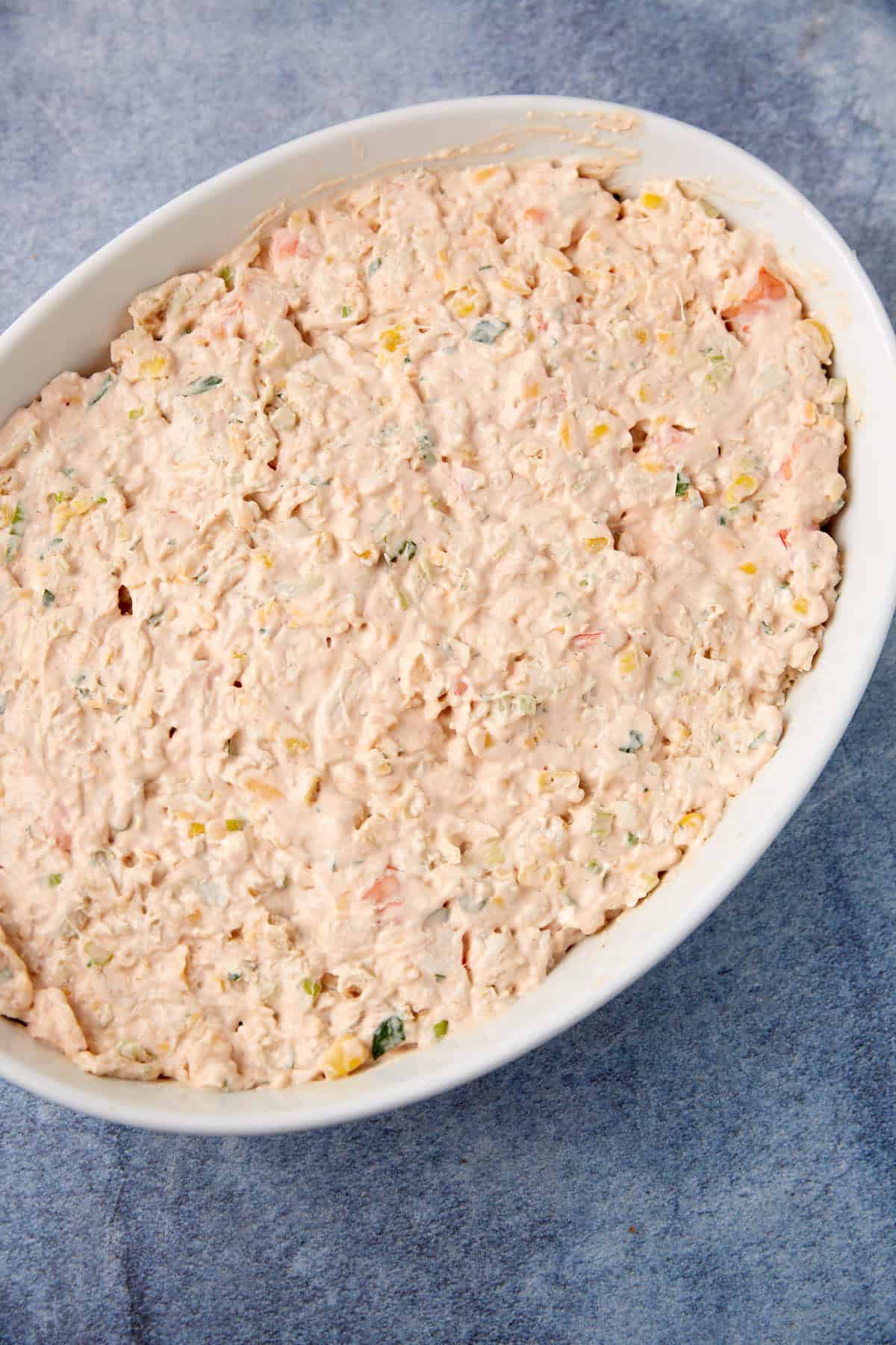 An unbaked seafood dip in a casserole dish.
