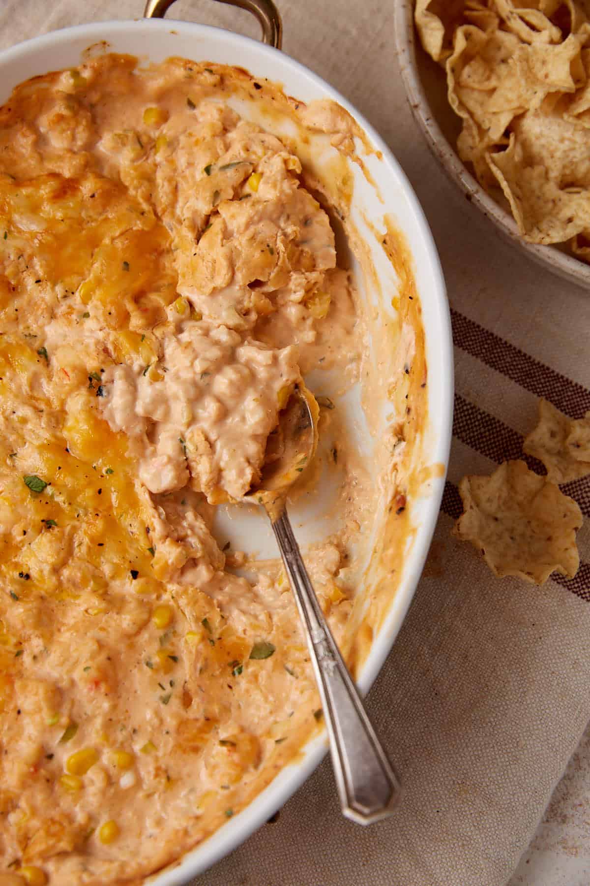 A serving spoon in a crab and shrimp dip.