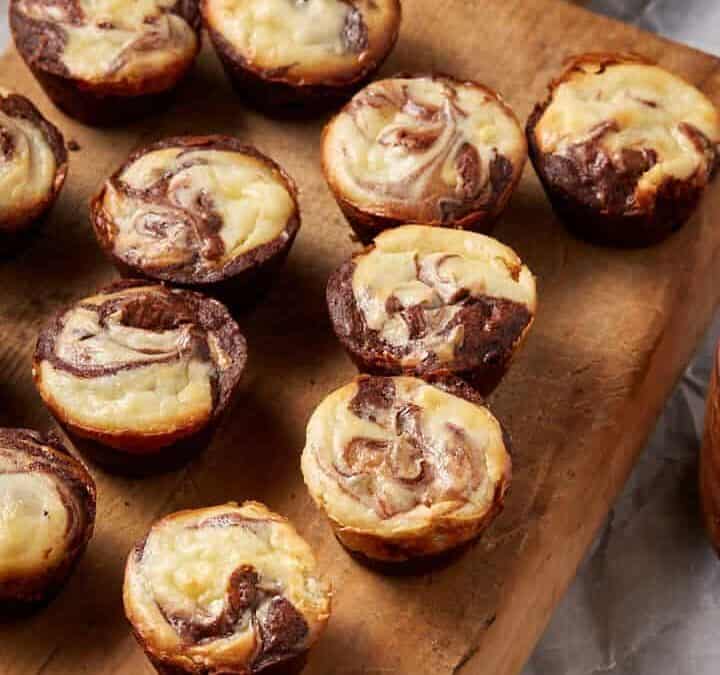 Mini brownies on a wooden board.