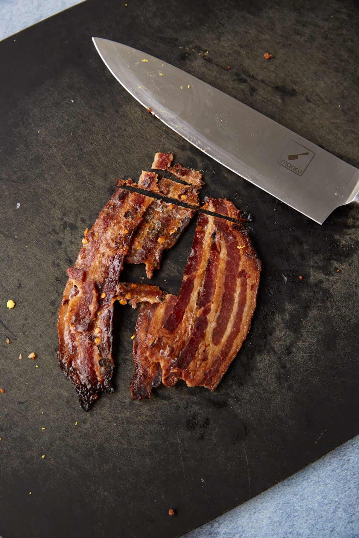 Candied bacon on a cutting board.