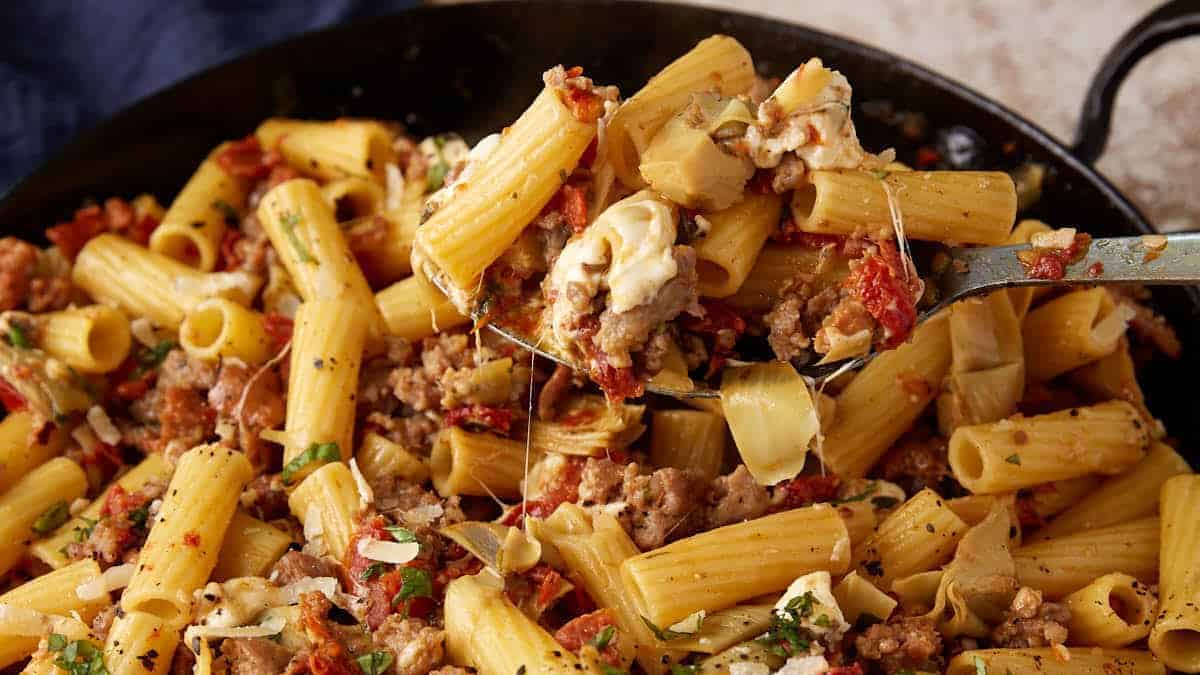 Sun-Dried pasta with artichokes in a skillet.