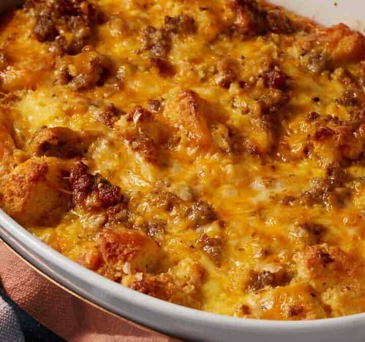 A quiche with sausage and cornbread in a casserole dish.
