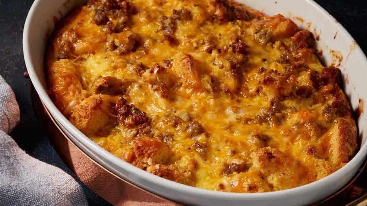 A quiche with sausage and cornbread in a casserole dish.