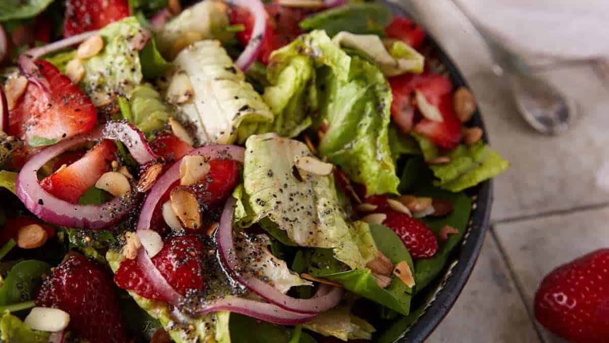 Fresh spinach salad topped with juicy strawberries.