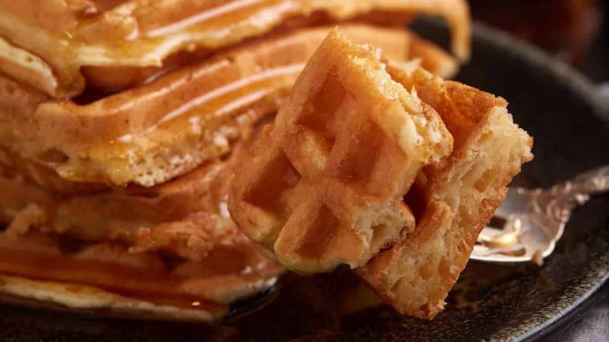 A bite of waffle on a fork.