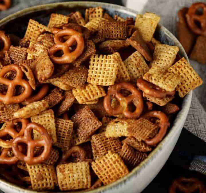 A bowl of buttery chex mix, with pretzels.