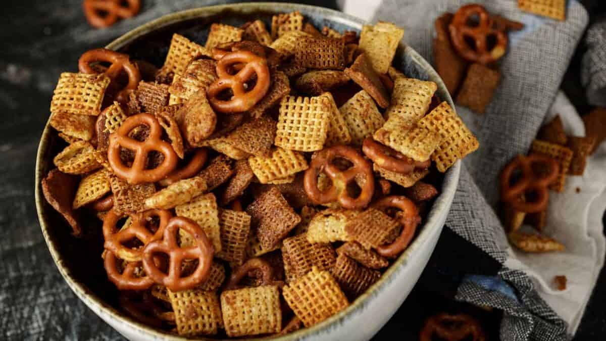 A bowl of buttery chex mix, with pretzels.