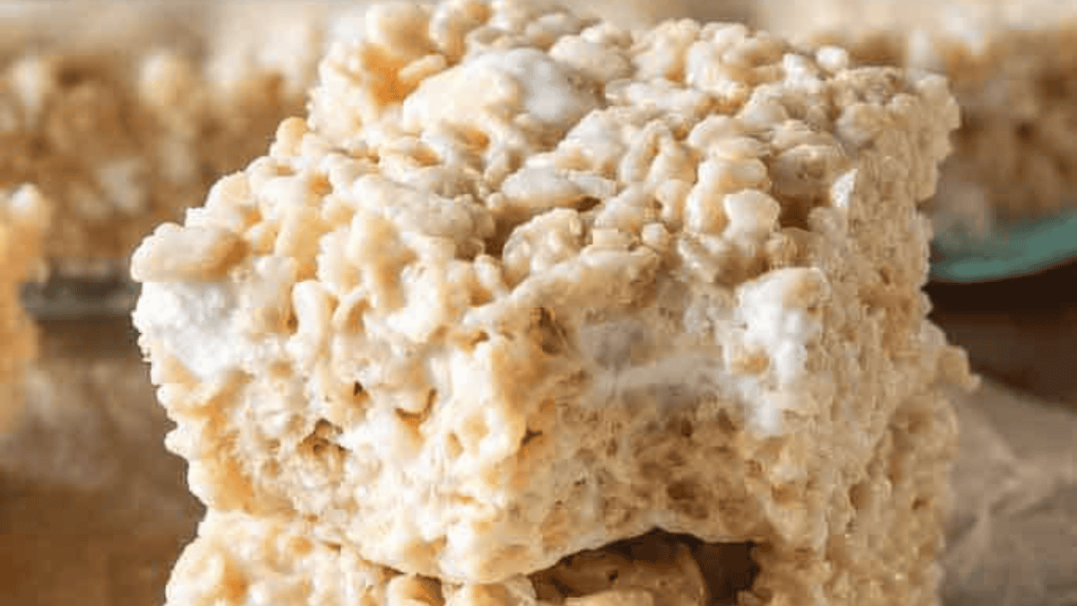 Close-up of two stacked rice krispie treats, highlighting their crispy, puffed rice texture and gooey marshmallow binding.