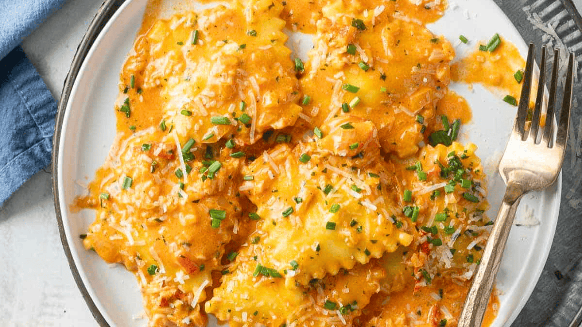 Lobster Ravioli with Tomato Cream on a plate.