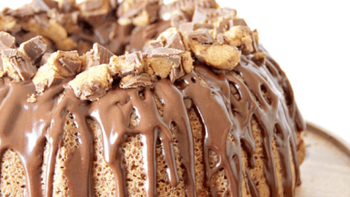 A bundt cake with chocolate icing and peanut butter.