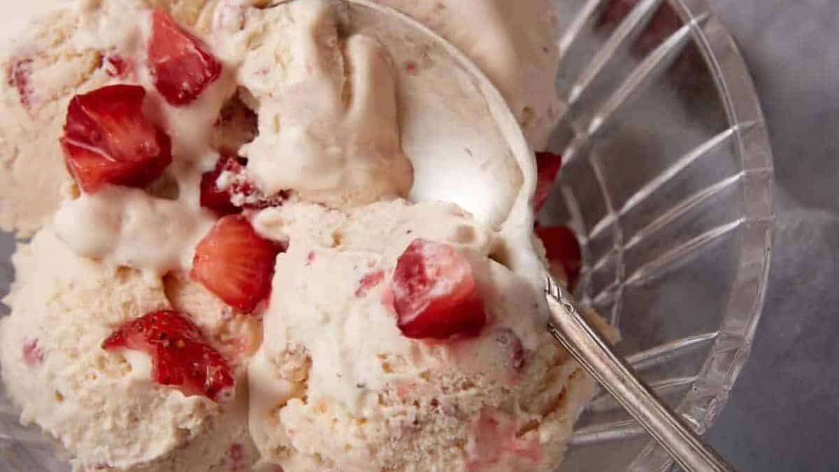 Scoops of strawberry ice cream in a bowl.