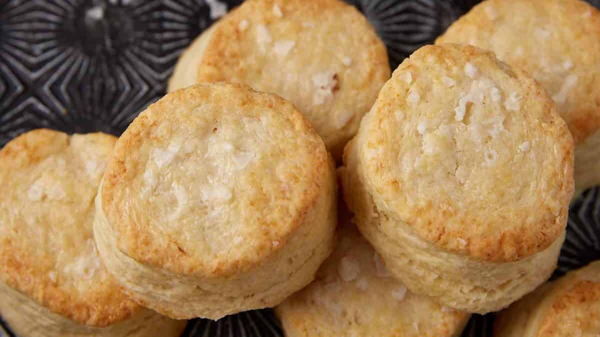 Southern biscuits on a tray next to a bowl of butter.