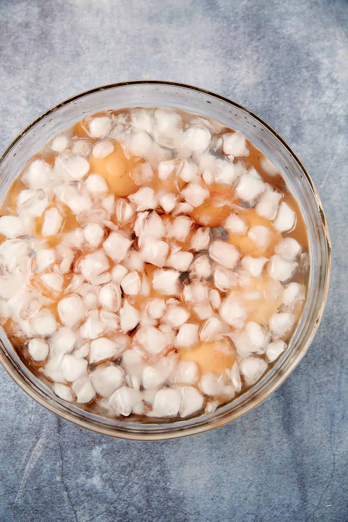 Hard boiled eggs in a bowl of ice water.
