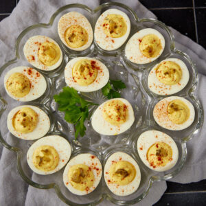 An egg platter filled with deviled eggs with relish.