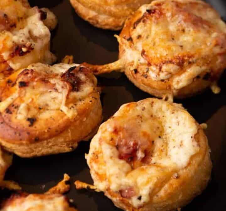 Mini Croque Monsieurs on a black platter.