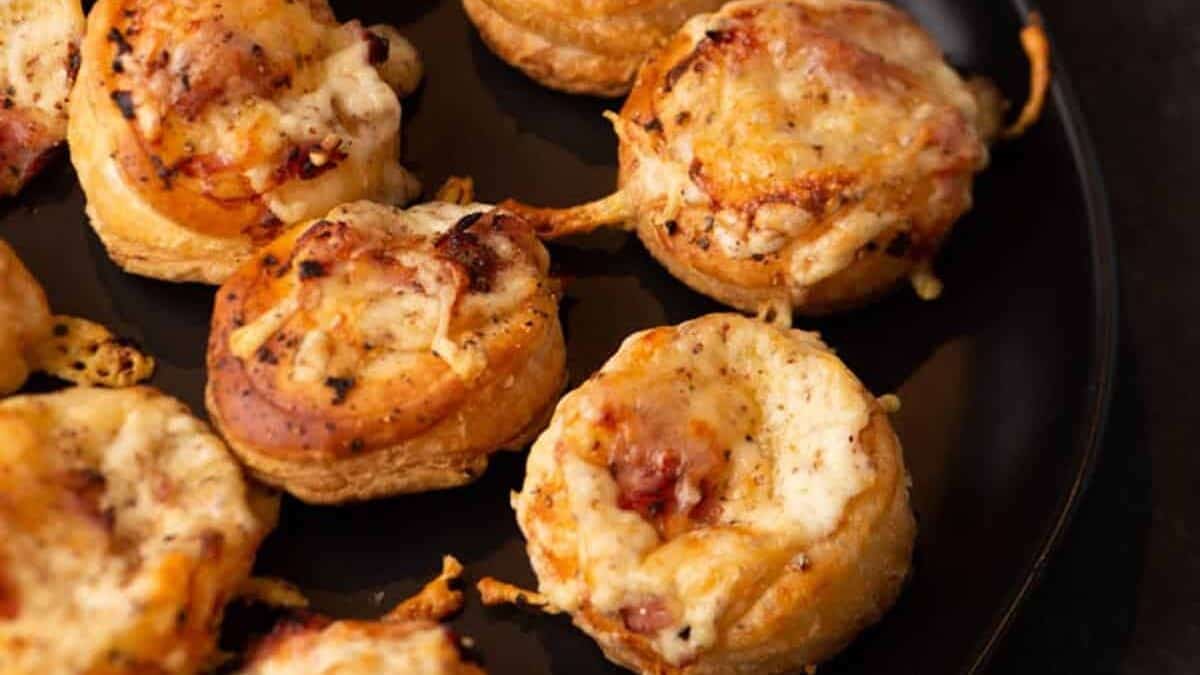 Mini Croque Monsieurs on a black platter.