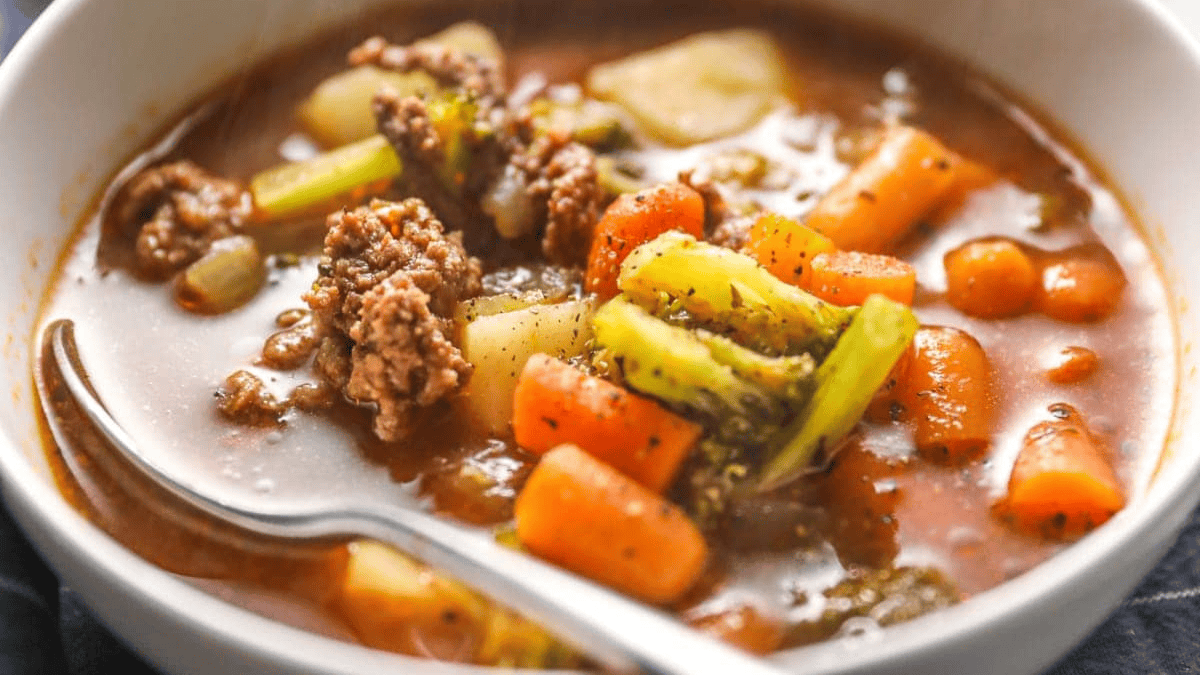 A bowl of soup with meat and vegetables.