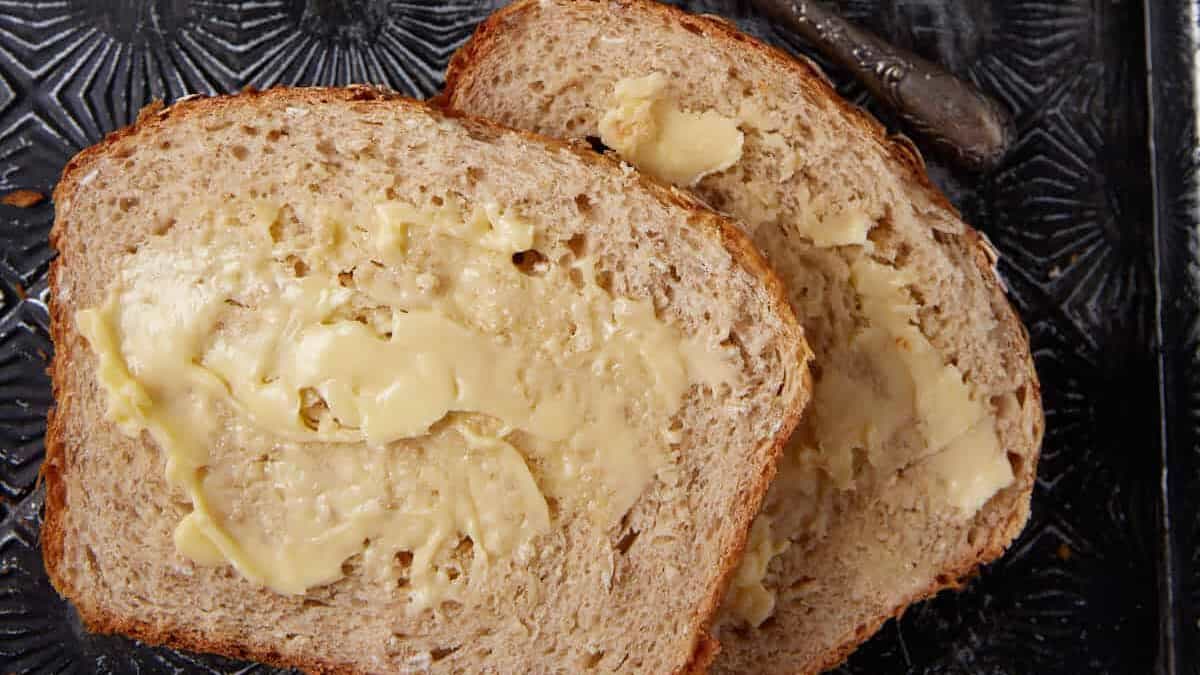 Slices of honey oatmeal bread on a tray.