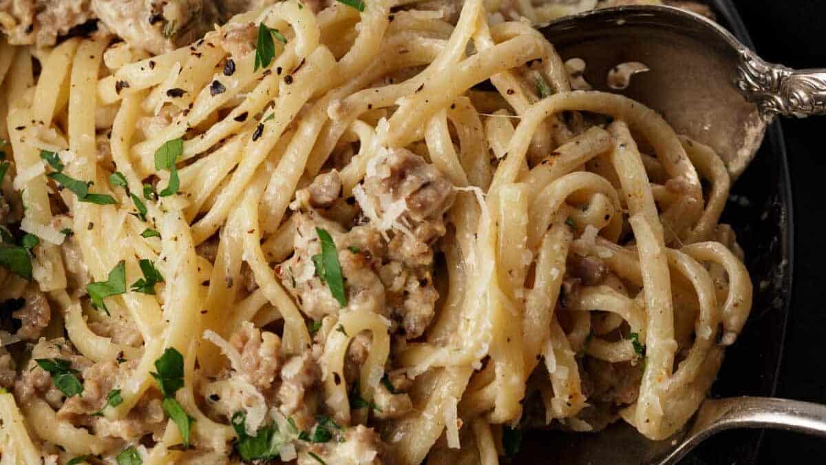 Creamy pasta with Italian sausage on a platter