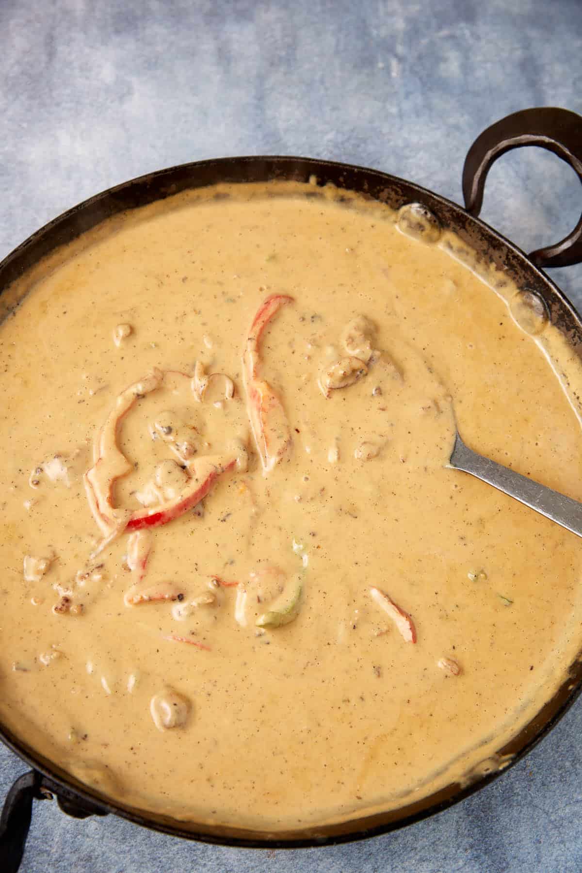 The cheese sauce in a skillet.