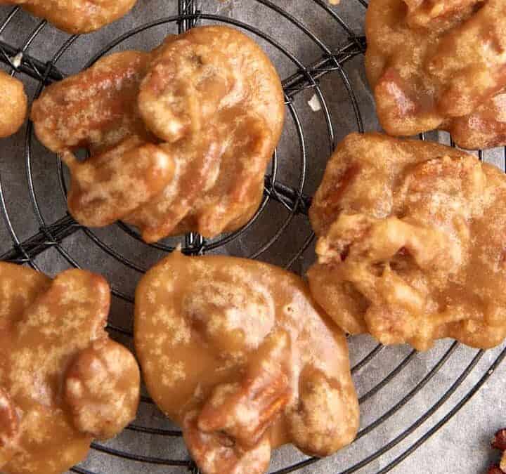 Pecan pralines on a cooling rack.