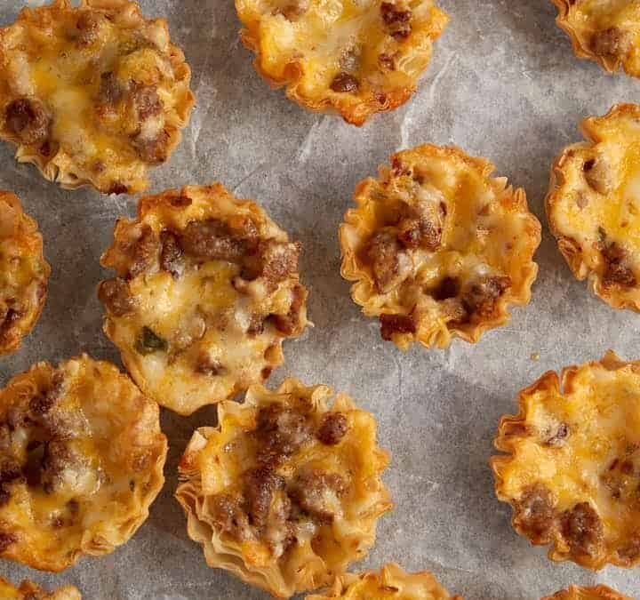A tray of mini cheese bites on a baking sheet