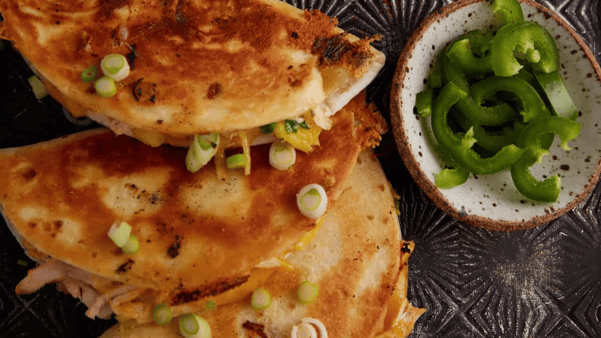 Chicken quesadillas filled with melted cheese and spices.