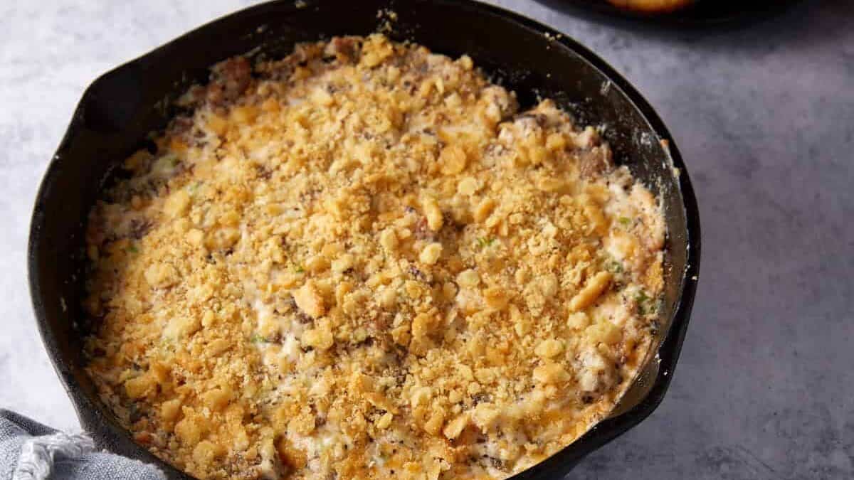 An iron skillet filled with cheesy bacon dip.