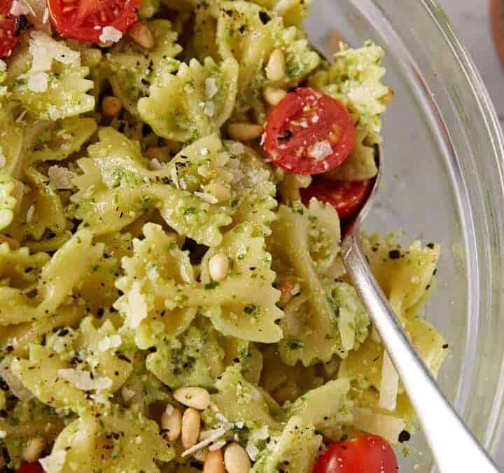 Refreshing summer pesto pasta salad perfect for picnics and gatherings in a serving bowl.