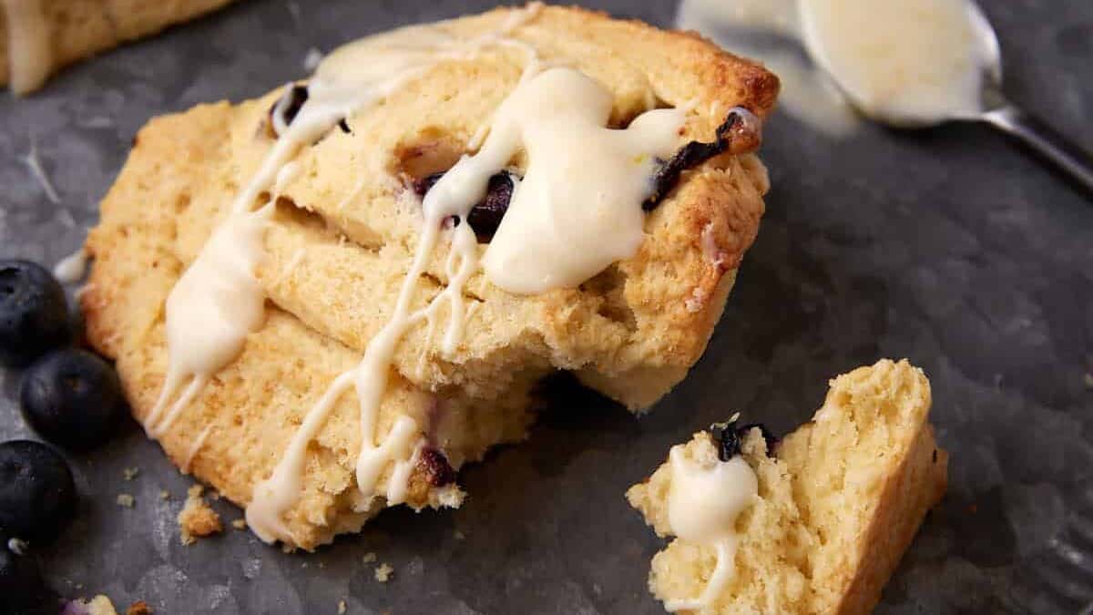 A blueberry scone broken apart on a plate.