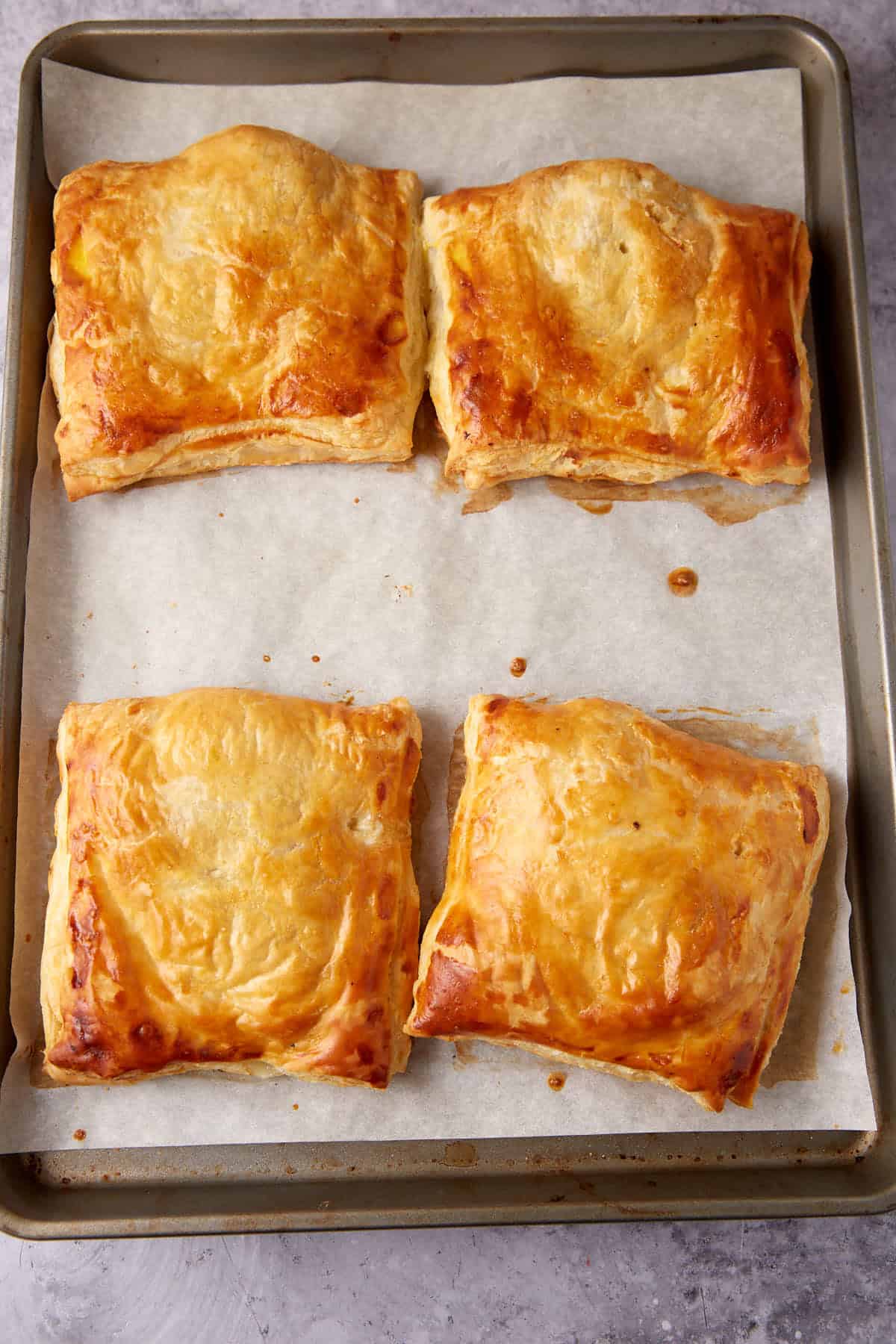 chicken in puff pastry baked on a baking sheet.
