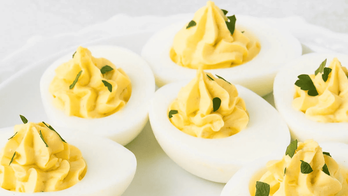 Deviled eggs with mustard and herbs.