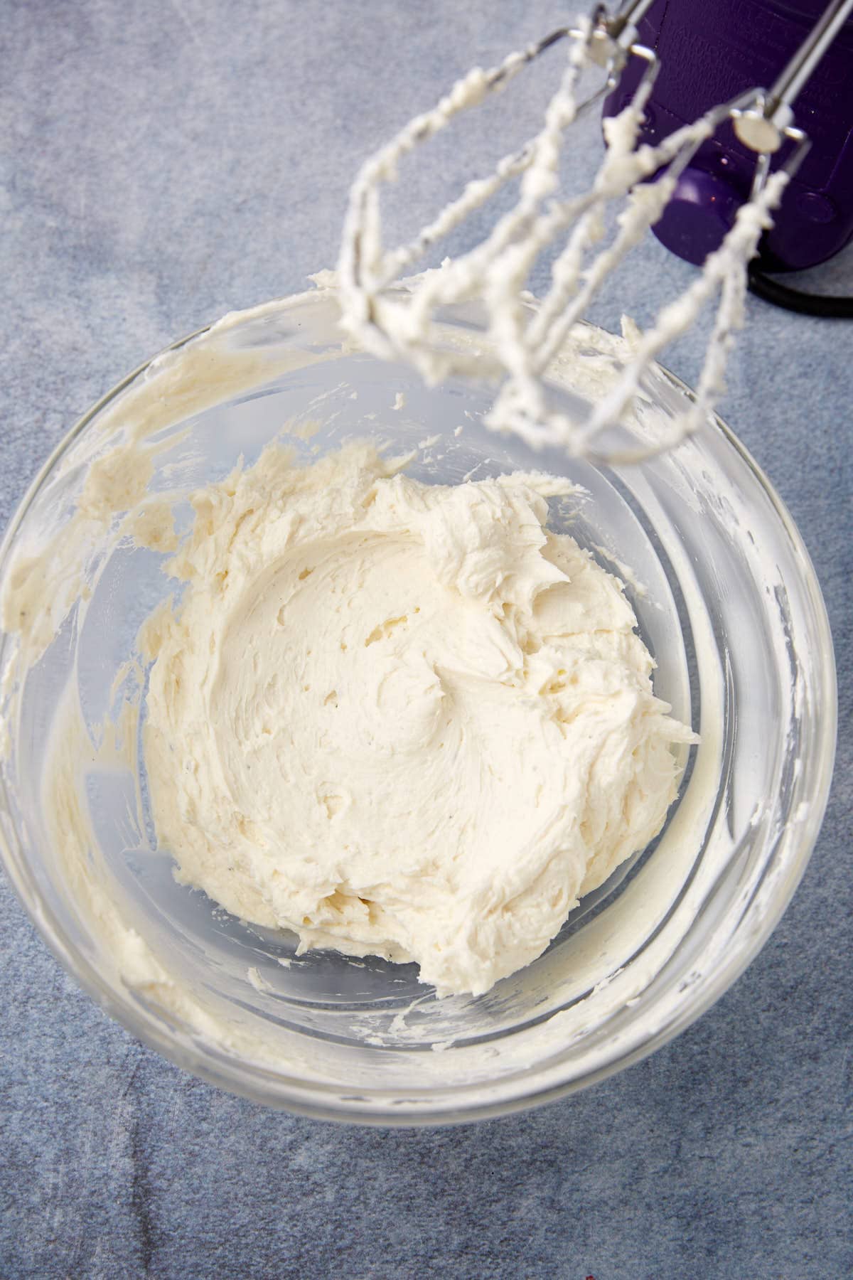 hand mixer mixing the goat cheese mixture.