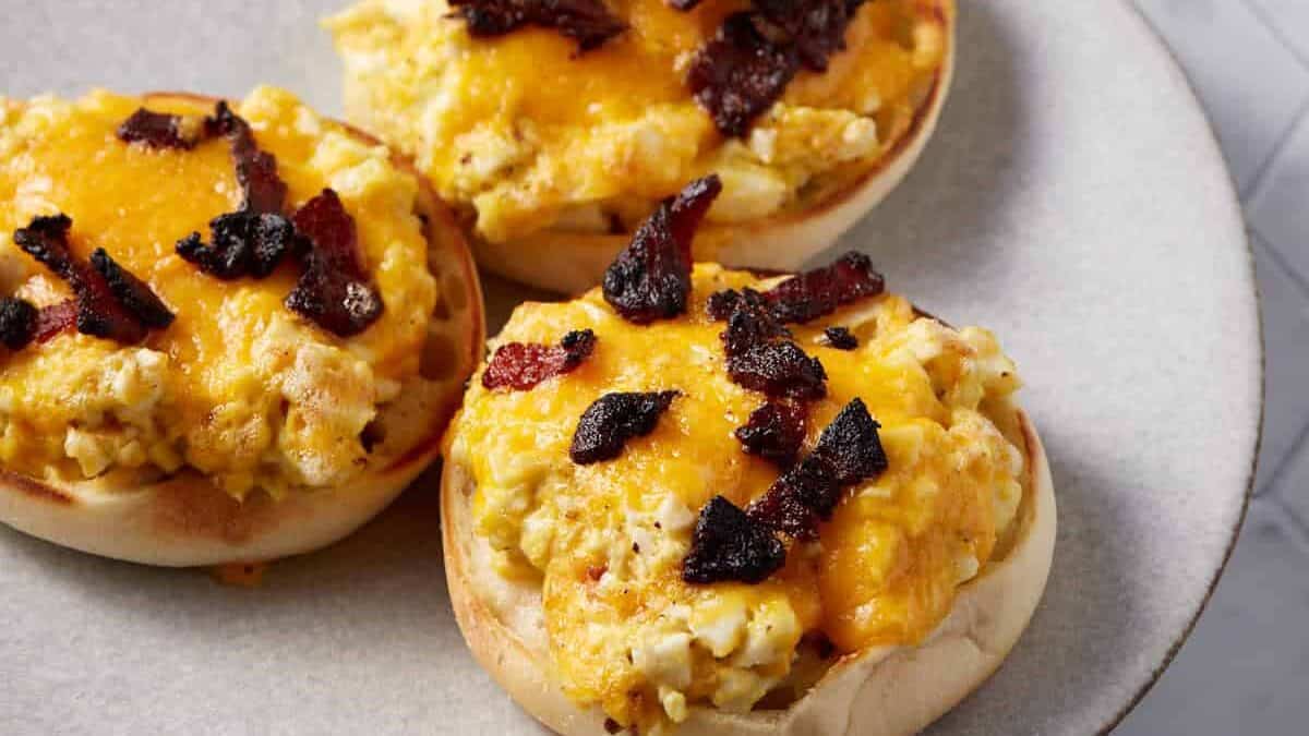 Three breakfast sandwiches on a plate.